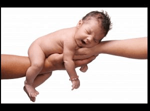 naked newborn baby sleeping two hands