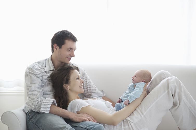 new parents holding newborn baby