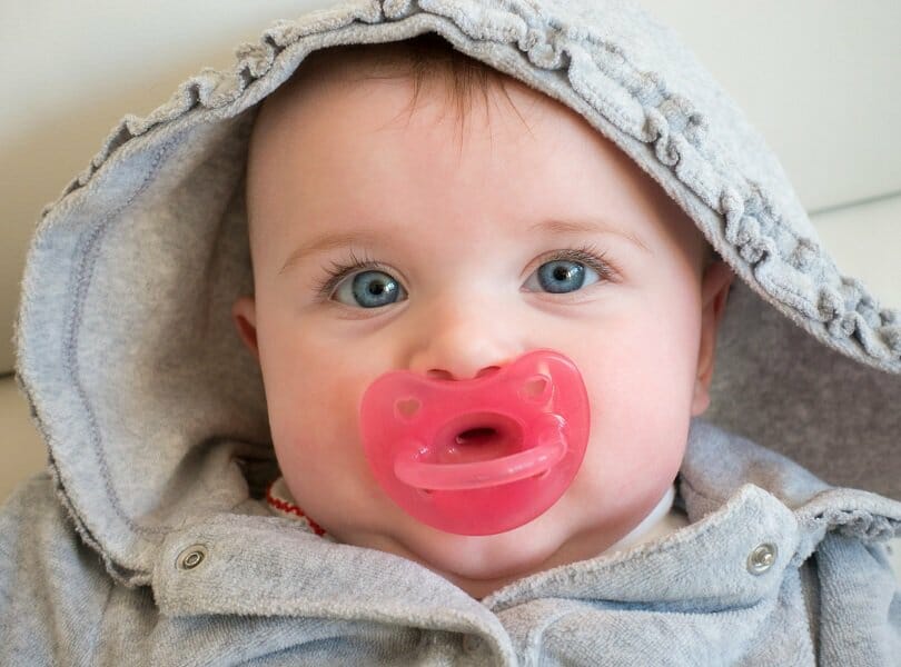 baby girl with pink pacifier