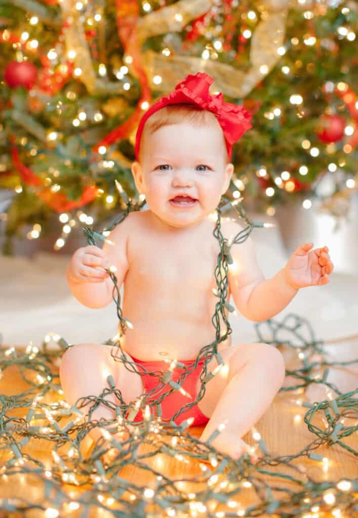 Baby at christmas with lights
