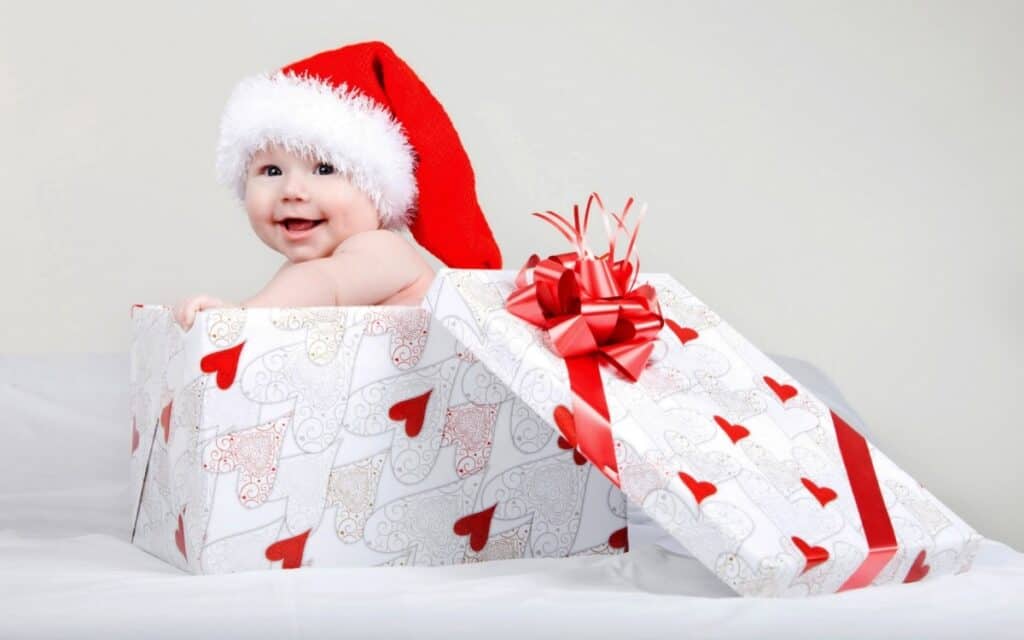 christmas baby as gift with santa hat
