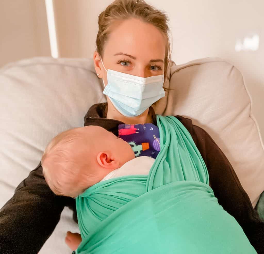 Katie Bishop with client's baby in mask