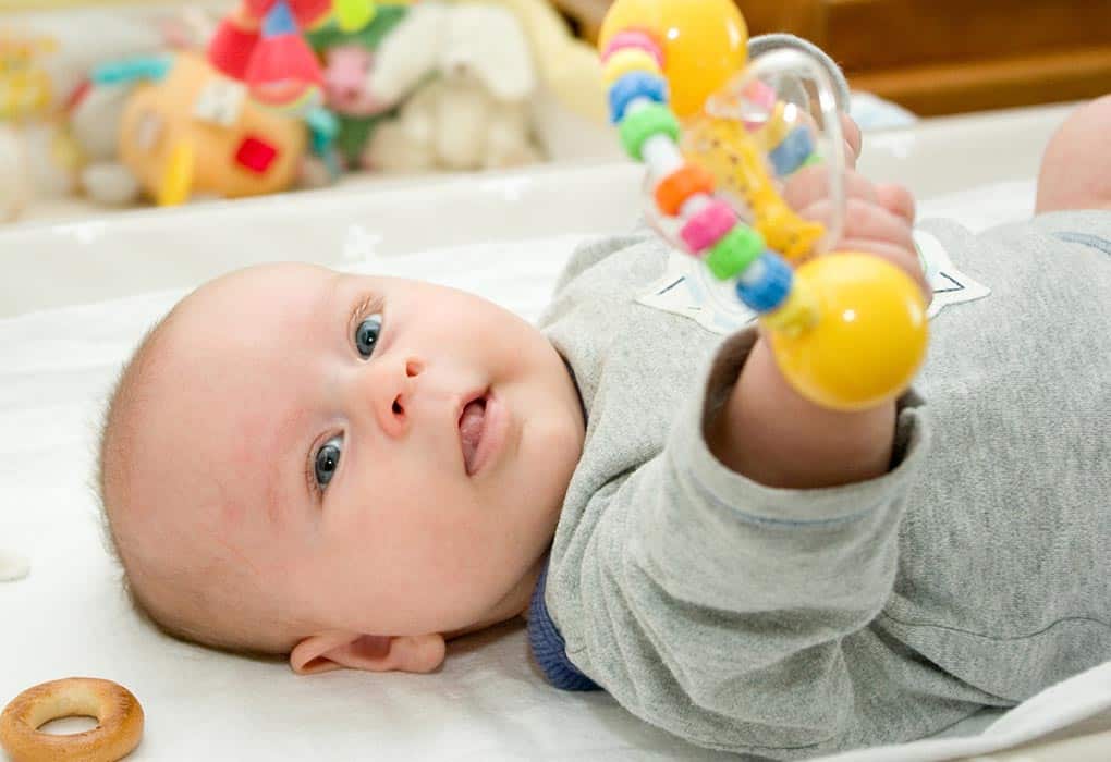 4 month old playing with toy