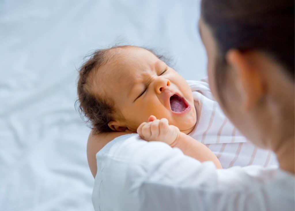 household employee holding infant