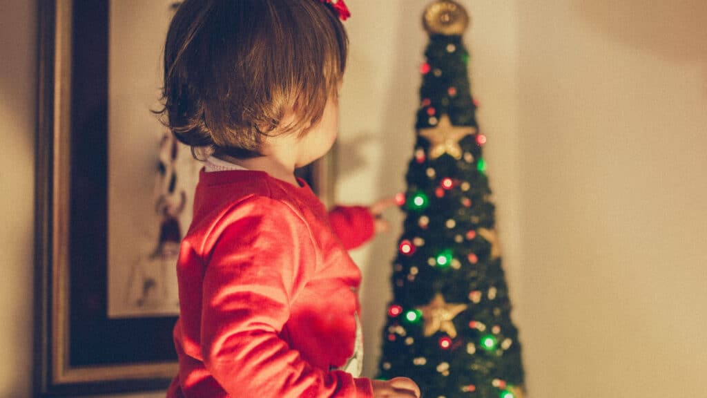 toddler decorating christmas tree