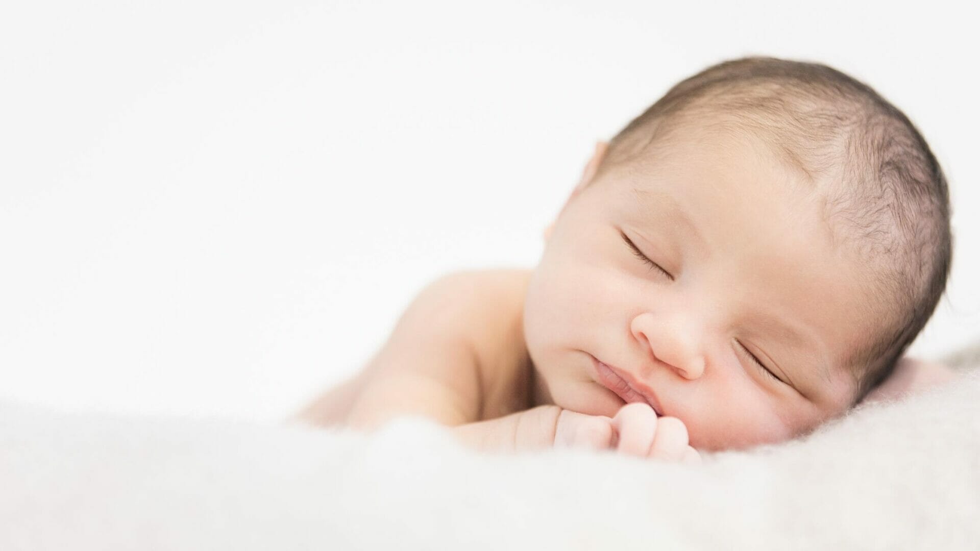 baby sleeping on blanket