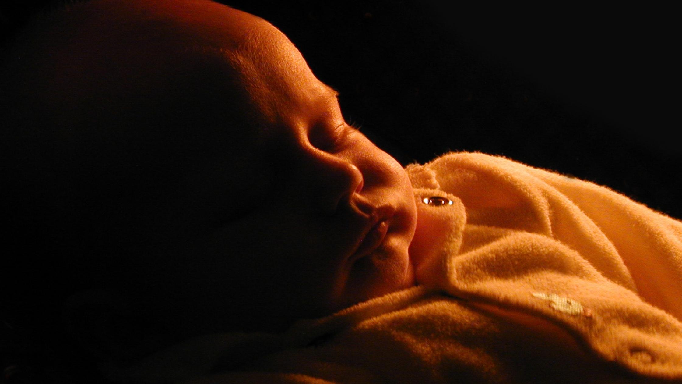 baby sleeping in dark night