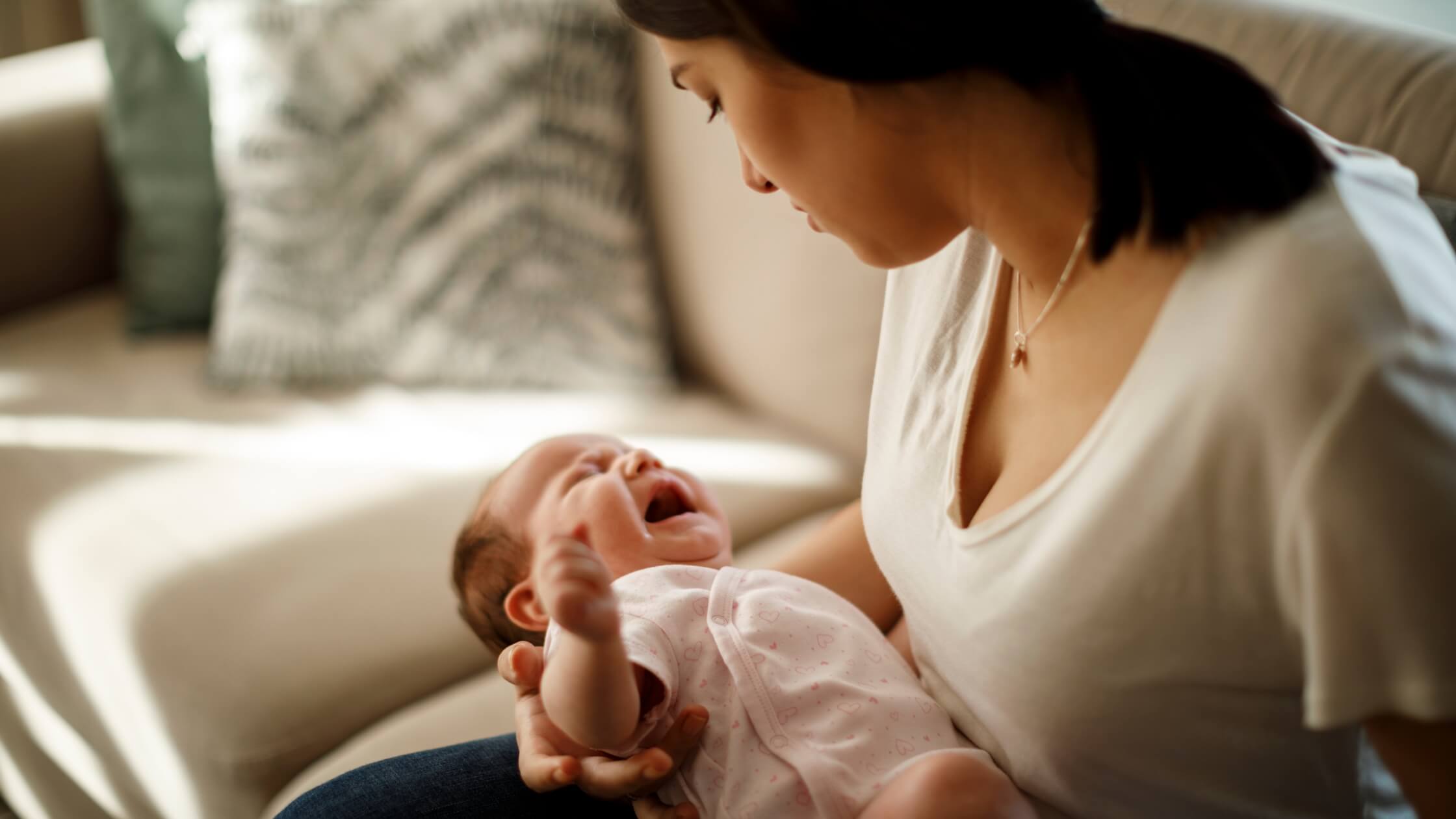 mom holding crying baby