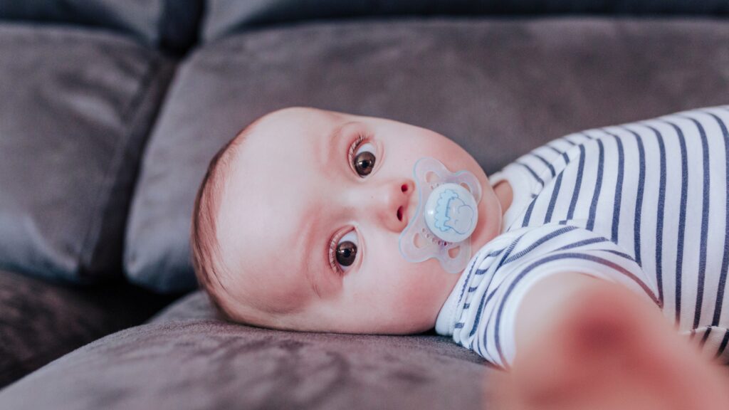 baby lying down with binkie