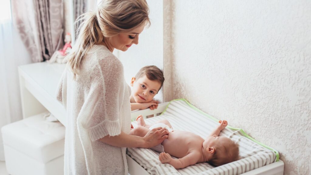 woman changing child on changing table