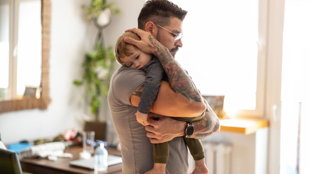 blog banner 2023 (3) abut 2 father holding sleeping toddler