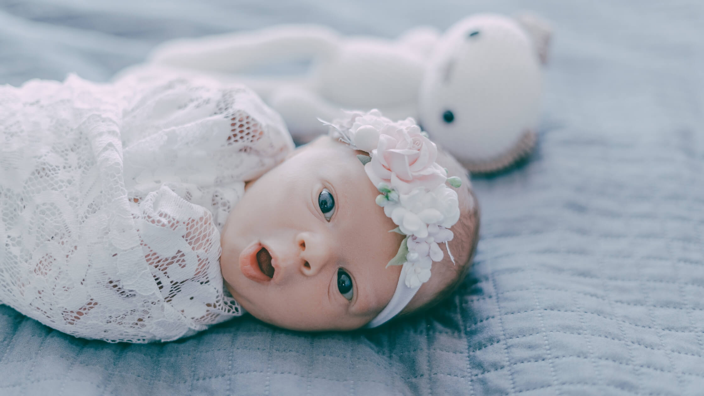 Baby swaddled on bed