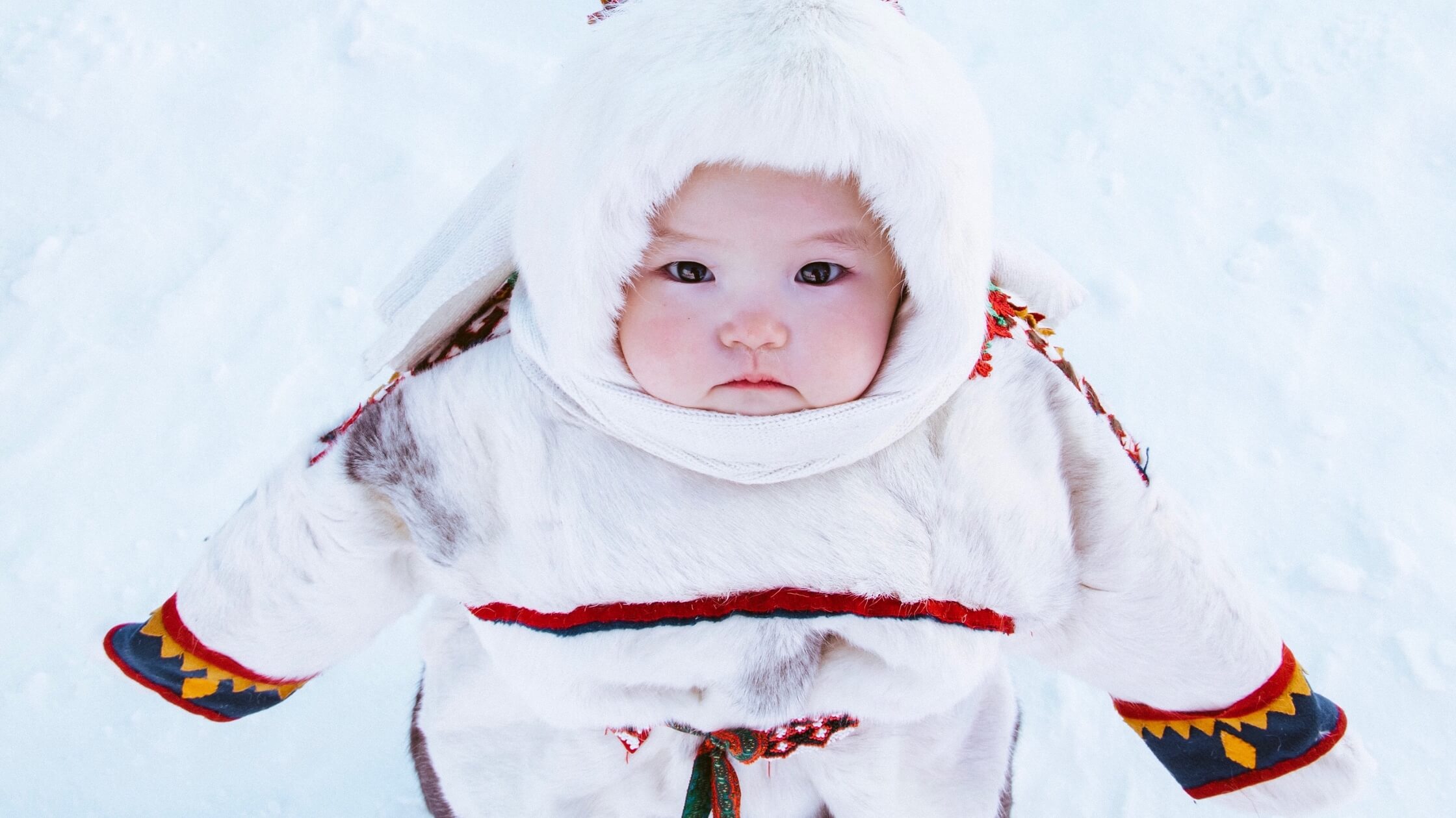 Baby bundled up in the snow