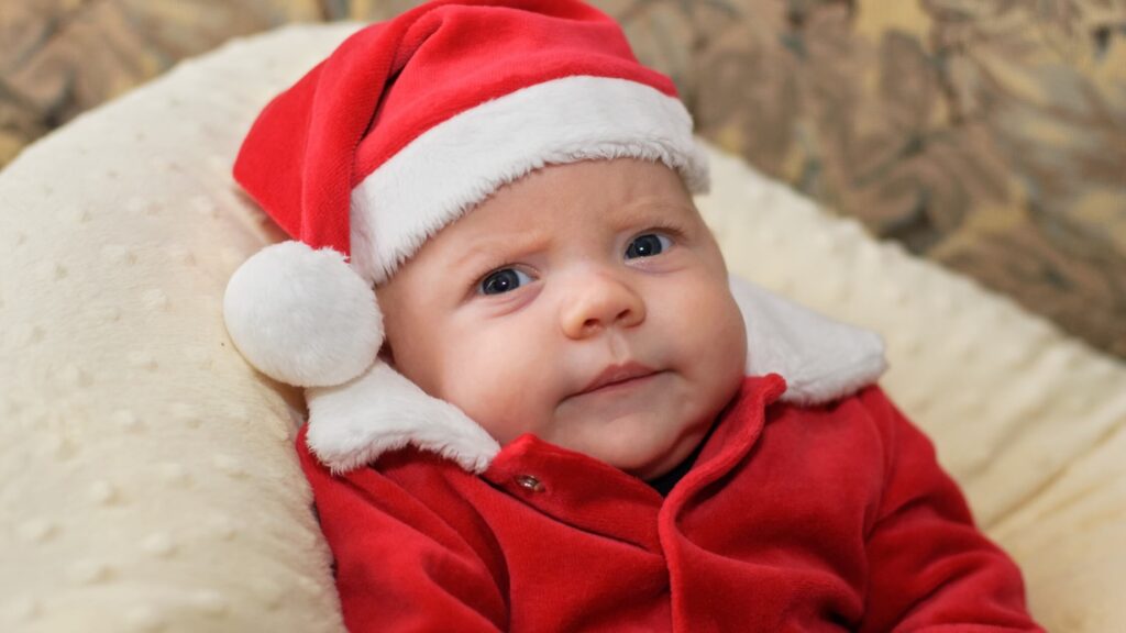 baby dressed in santa costume grumpy
