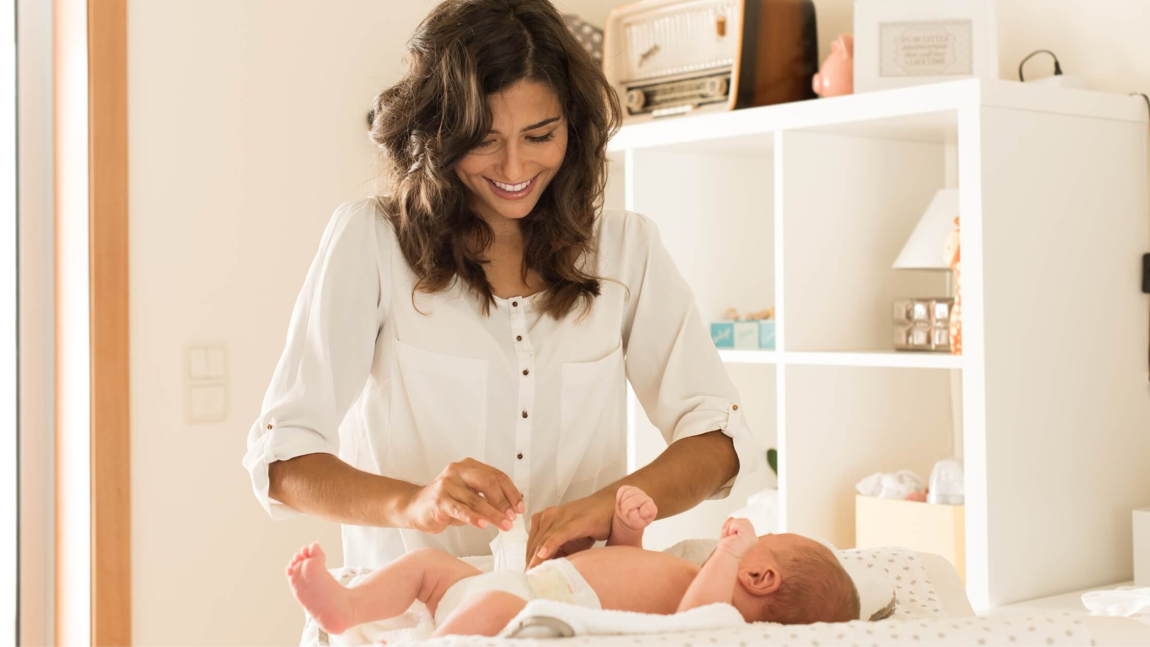 mother changing baby at changing table