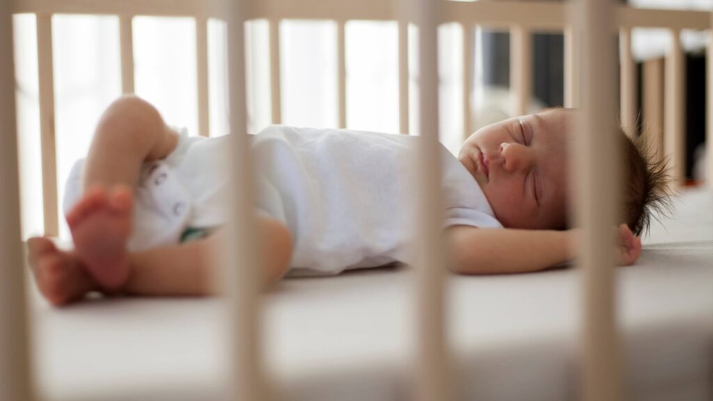 newborn baby sleeping peacefully in crib