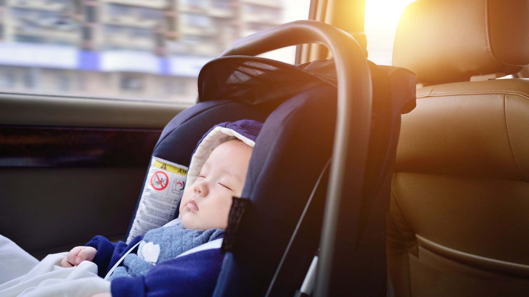 baby sleeping in car in car seat