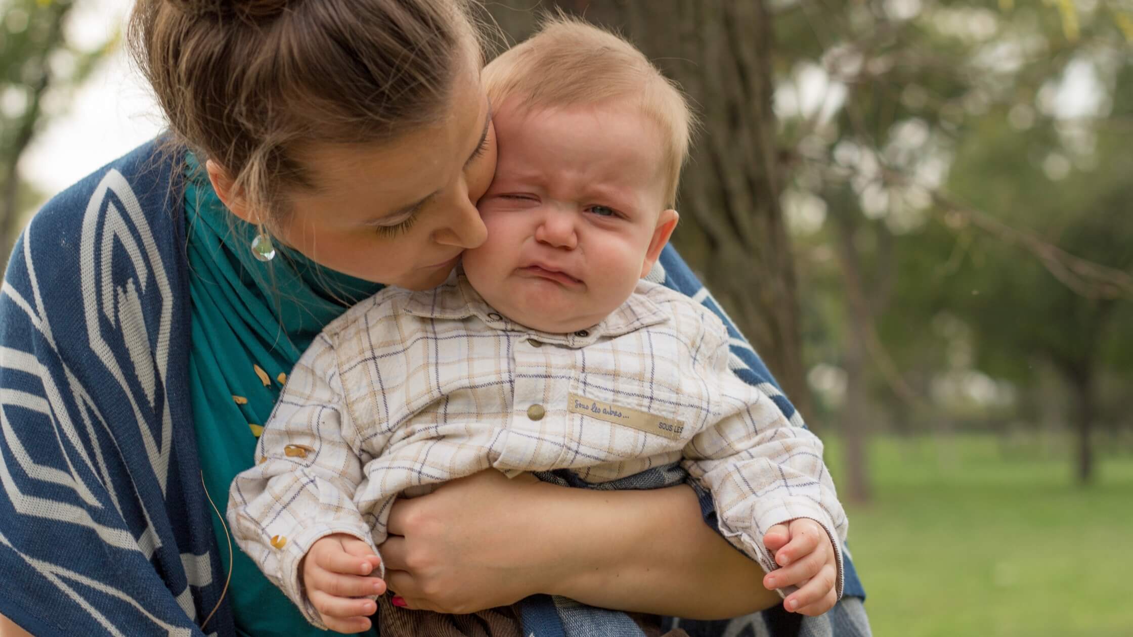 mother holding baby who is crying