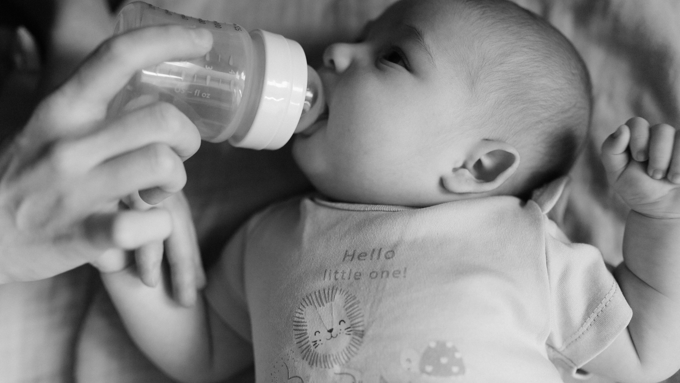 baby being fed by a bottle