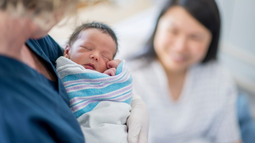 night nurse helping mother with baby at night