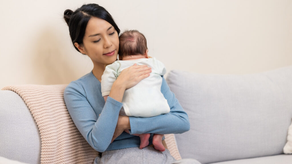 burp baby blog banner Momma holding baby and burping them after feeding