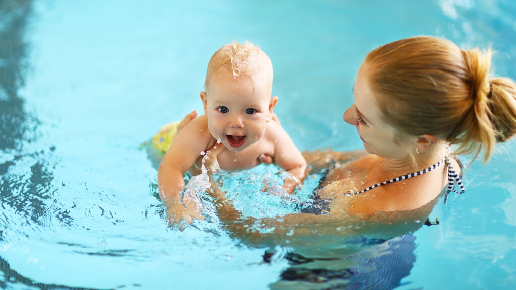 summer travel tips with baby 2 mother and baby swimming in pool summer