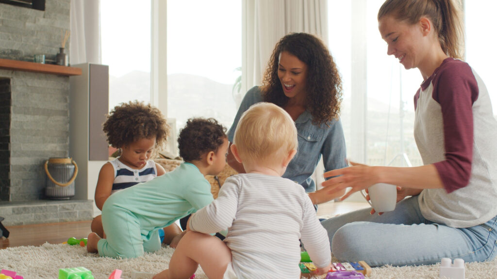 two babies and their moms on a play date