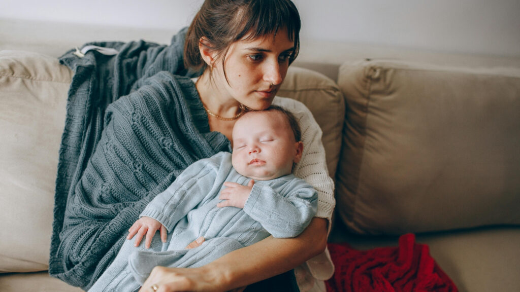 mom holding sleeping baby