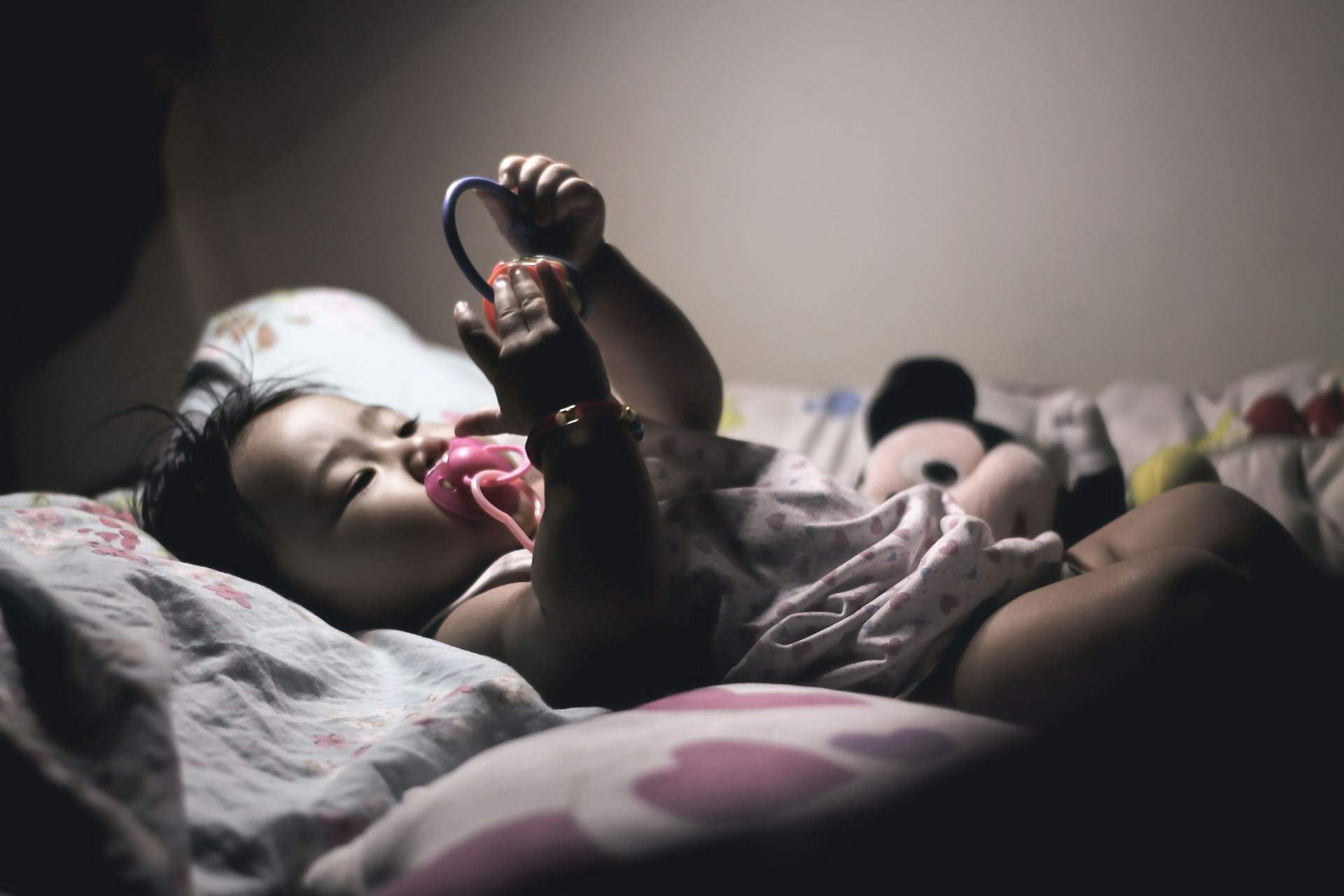 baby at night in bed with binkie