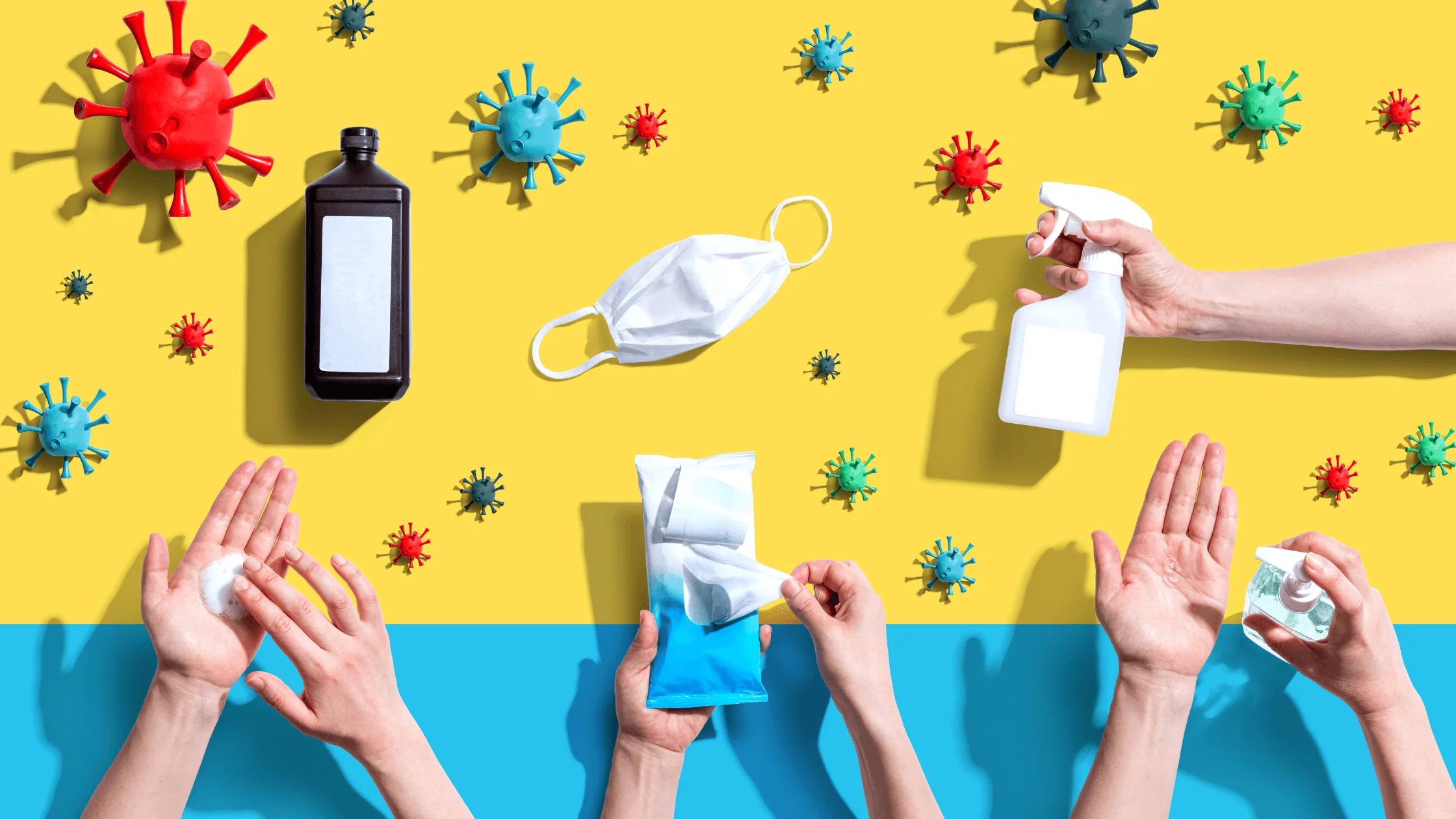 hands and germs on a display with a yellow background and various cleaning supplies