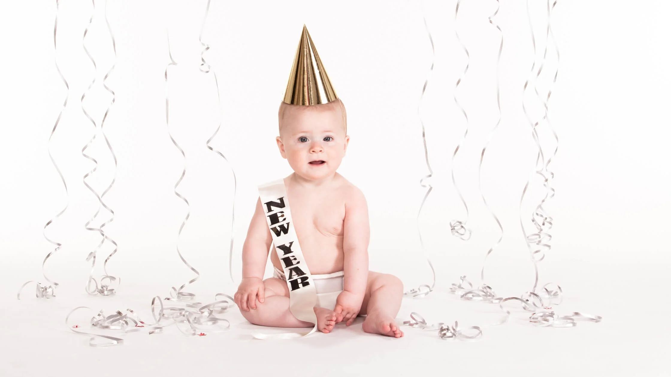 baby with birthday party hat