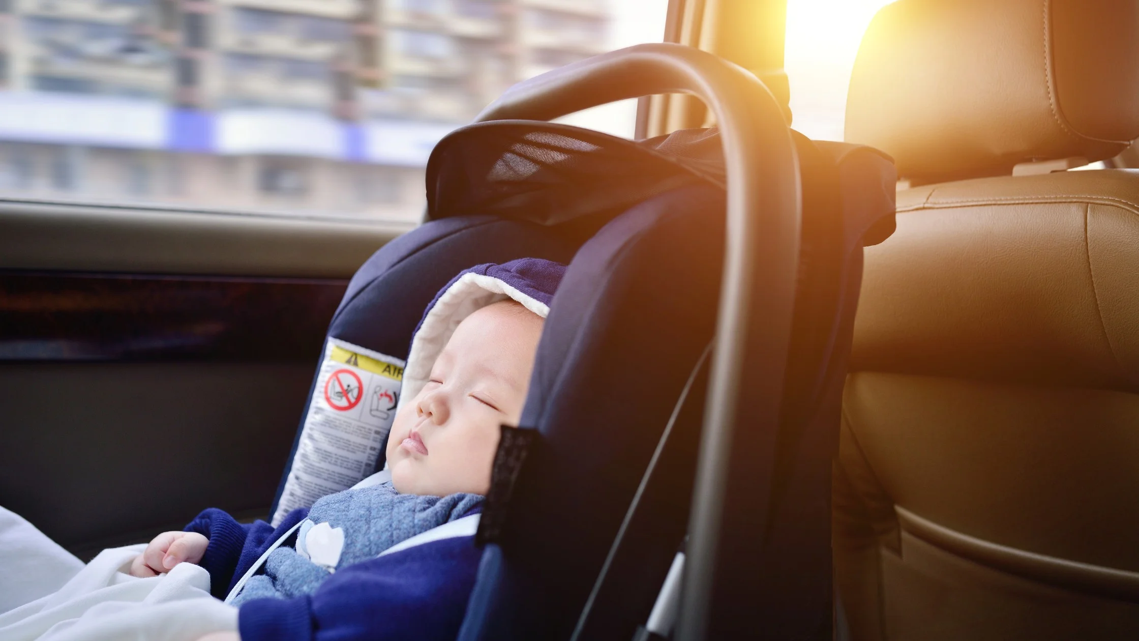 baby sleeping in car in car seat
