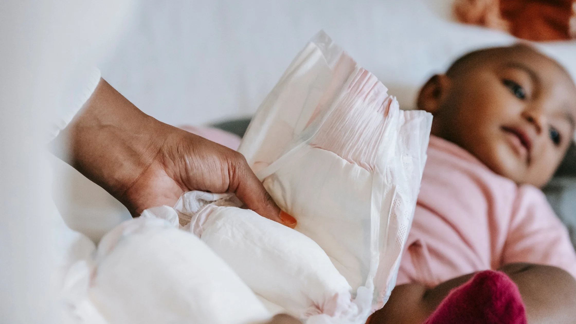 mother changing baby's diaper