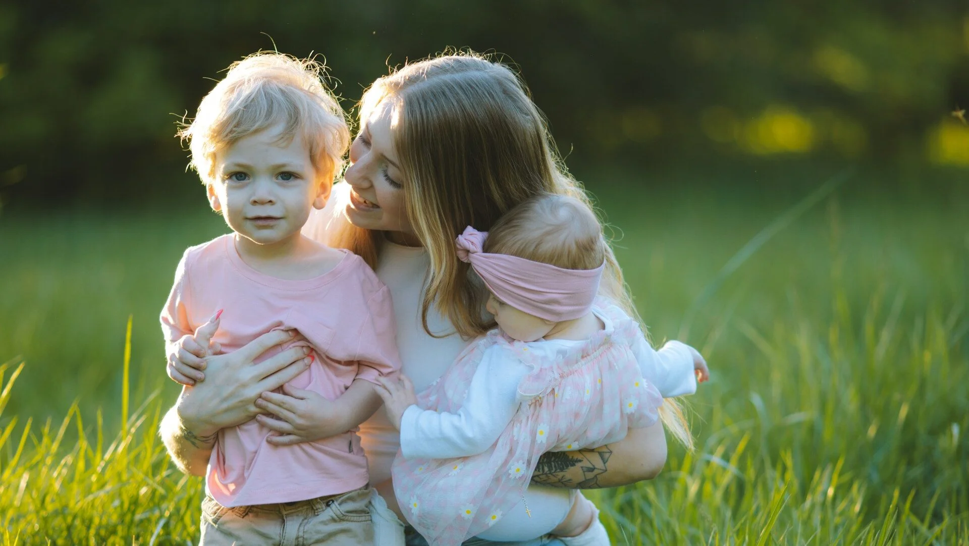 woman and her baby and toddler in a field